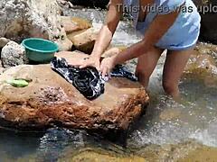 Crossdressing couple washes in a river